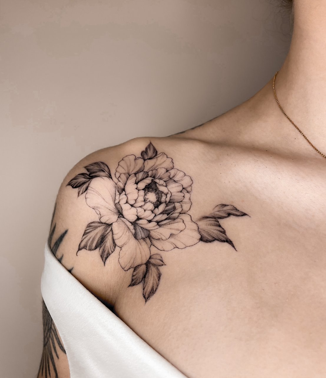 Peony flower on the shoulder 
